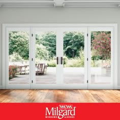 an empty room with sliding glass doors and wood flooring in front of the door