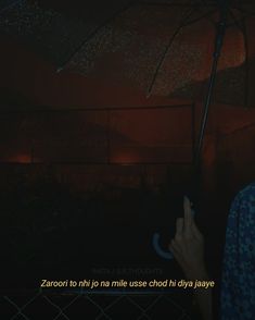 a person holding an umbrella in the dark