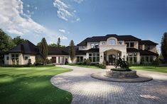 a large house with a fountain in the front yard