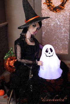 a doll dressed up as a witch with a ghost