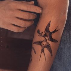 a man with a bird tattoo on his arm