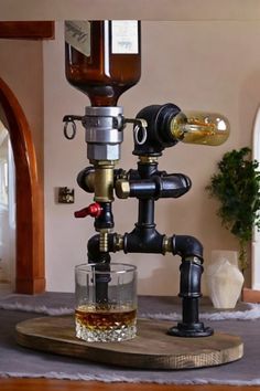 a glass filled with liquid sitting on top of a wooden table