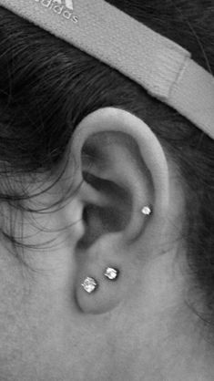 a woman with ear piercings on her head