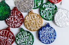 christmas ornament ornaments with glitter and words on them, all in different colors