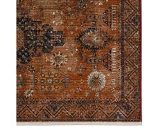 an orange and black rug with many different designs on it's sides, including the center