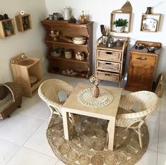 a living room filled with furniture and baskets on top of it's floor next to a wall