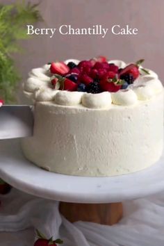 there is a cake with berries on it and the words berry chanlly cake above it