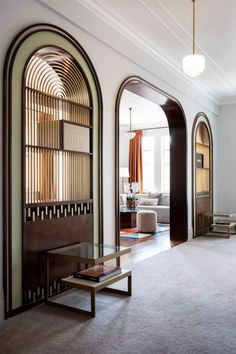 a living room filled with furniture and arched doorways