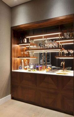 a kitchen with wooden cabinets and shelves filled with wine glasses