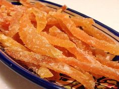 some kind of food that is on a blue and white plate with orange peels