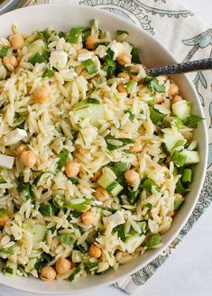 a white bowl filled with rice and vegetables