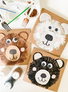 three paper plates with animal faces on them, one is brown and the other is white