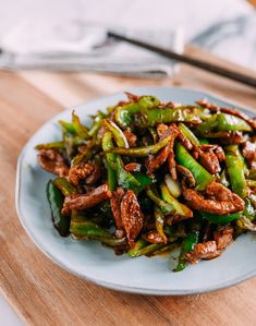 a plate full of stir fried vegetables on a wooden table