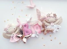 some pink and gold hair clips on top of a white surface with stars in the background