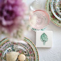 a table topped with plates covered in flowers