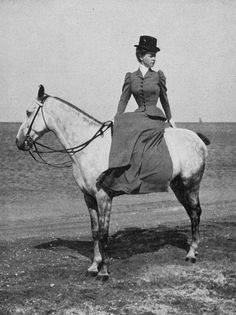 an old photo of a woman on a horse