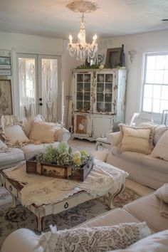 a living room filled with furniture and a chandelier