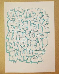 the letters are drawn in blue ink on white paper with green marker pens and pencils