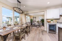 a kitchen and dining room with large windows