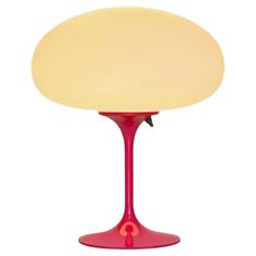 a red table lamp with a white light on it's base and a yellow shade