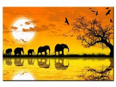 a group of elephants walking across a lake at sunset