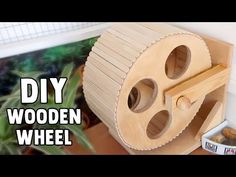 a wooden wheel is sitting on the floor