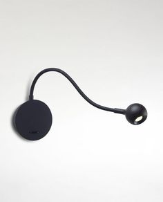 a black wall light with a cord attached to the back of it's head