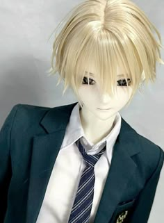 a male mannequin with blonde hair wearing a blue suit and striped neck tie