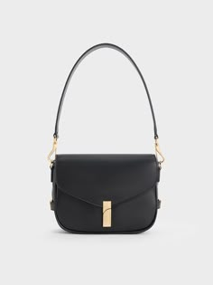 Sleek and sophisticated, this Aurelia saddle bag is a modern classic that will never go out of style. Featuring a timeless silhouette and a versatile black finish, this polished carrier stands out with its distinctive gold-tone hardware. A chic turn-lock closure -- taking the form of a narrow vertical bar -- is the striking centrepiece of this design. This bag also comes with an adjustable strap that you can clip on easily to transform it into a handy crossbody bag. Vertical Bar, Black Cross, Charles Keith, Saddle Bag, Black Cross Body Bag, Metallic Accents, Modern Classic, Body Bag, Saddle Bags