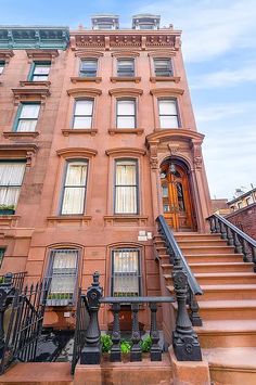 an apartment building with stairs leading up to it