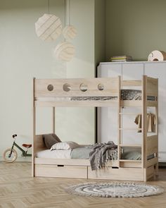 a wooden bunk bed sitting on top of a hard wood floor next to a white cabinet