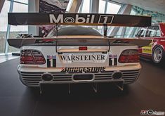 two cars are on display in a museum