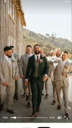 a group of men in suits walking down a street