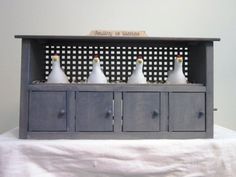 a group of white birds sitting on top of a wooden cabinet