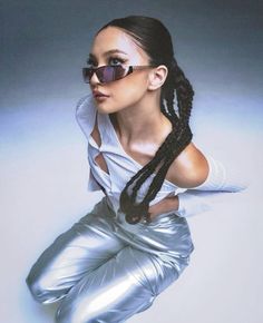 a woman in shiny silver pants and sunglasses