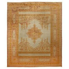 an antique rug with orange and yellow colors