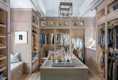 a walk in closet filled with lots of clothes