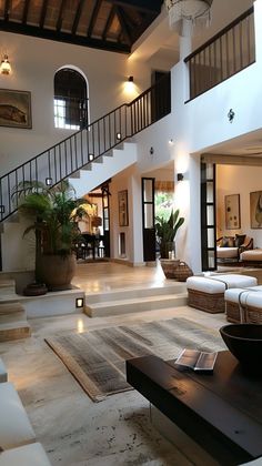 a living room filled with furniture and a staircase