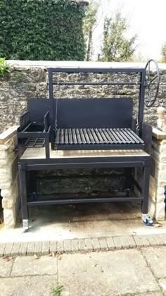 an outdoor bbq grill sitting next to a brick wall