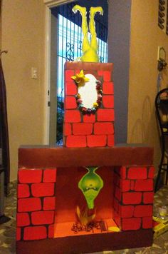 a cardboard castle made to look like the grinch from how the grinch stole