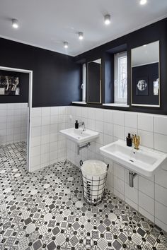 a black and white bathroom with two sinks