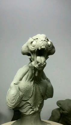 a sculpture of a rat on top of a table with its head in the air