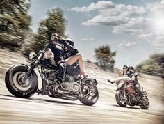 two people riding motorcycles on a dirt road