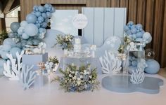 a table topped with blue and white decorations