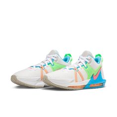 a pair of white and blue sneakers with neon green accents on the upper part of the shoe