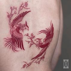 a woman with a tattoo on her back has a bird and branch in the shape of a heart