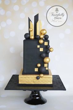 a black and gold birthday cake on a table