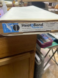 there is a box on top of the table that says heat and bond in it