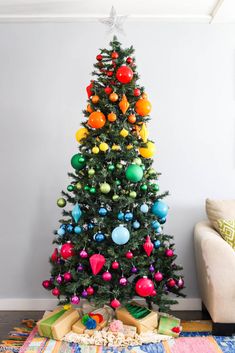 a brightly colored christmas tree in a living room