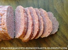 slices of meat sitting on top of a wooden cutting board